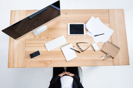 top view of pregnant businesswoman sitting at workplace in modern officeの写真素材