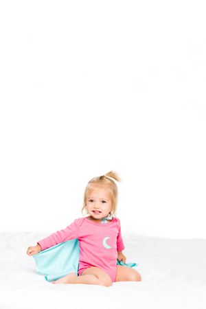 cute baby in superhero cape and bodysuit isolated on whiteの写真素材
