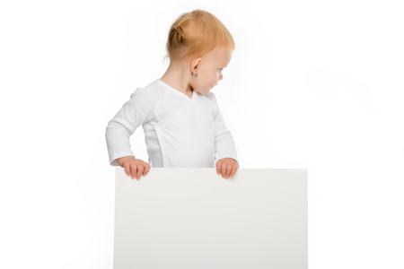 toddler girl holding blank banner in hands and looking away isolated on whiteの写真素材