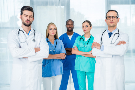 multiethnic team of doctors with crossed arms looking at cameraの写真素材