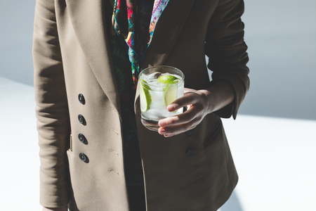 cropped shot of person holding glass with gin tonic cocktailの写真素材