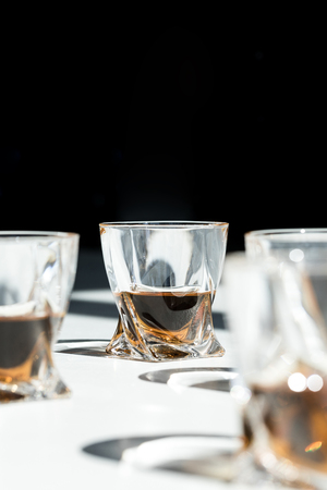 close-up view of luxury whiskey in glasses on blackの写真素材