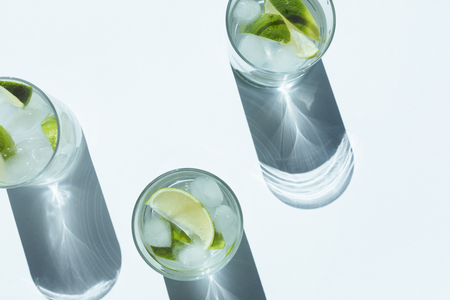 top view of Gin Tonic cocktail with lime and ice cubes in glasses  の写真素材