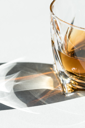 close-up view of luxury cognac in glass on white の写真素材
