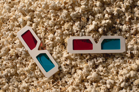 top view of tasty popcorn with 3d glassesの写真素材