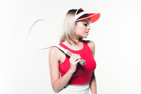 portrait of stylish woman with tennis racket posing isolated on whiteの写真素材