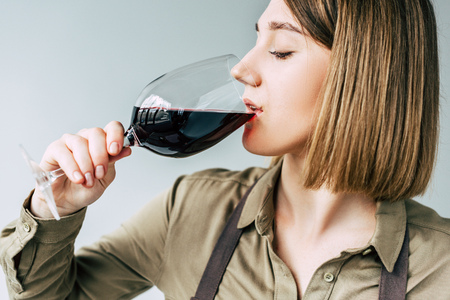 Portrait of Female sommelier tasting red wine の写真素材
