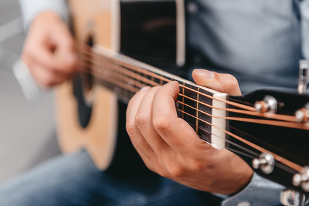 Cropped shot of man playing acoustic guitarの写真素材
