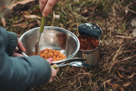 Cropped image of Man and woman preparing to eat beans on a natureの写真素材
