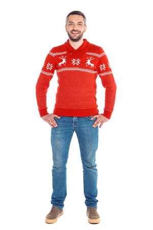 man standing in red christmas sweater, isolated on whiteの写真素材