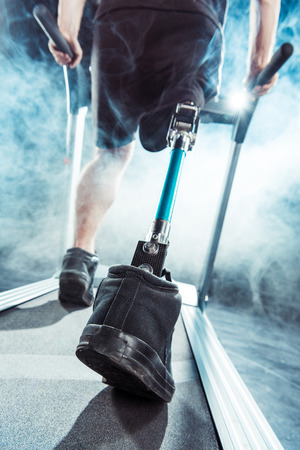 selective focus of sportsman with leg prosthesis training on treadmillの写真素材