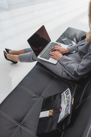 high angle view of businesswoman working with laptopの写真素材
