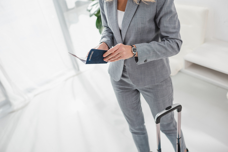 cropped shot of businesswoman with passport and flight ticket ready for tripの写真素材