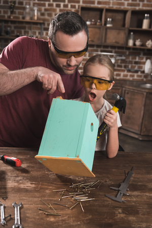 Daughter surprised to wooden handmade birdhouse の写真素材