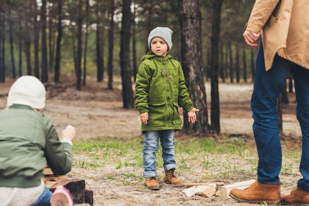 serious little boy spending time on nature with familyの写真素材