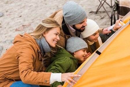 beautiful young family looking at camping tentの写真素材