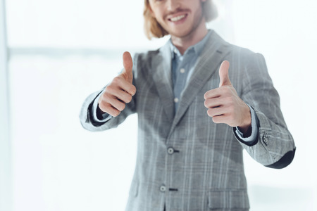 cropped image of businessman showing thumbs upの写真素材