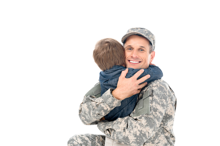 happy handsome father in military uniform embracing with son isolated on white