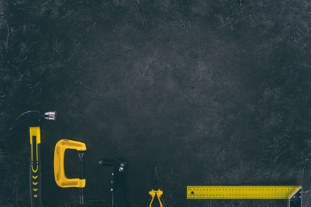 top view of various mechanical tools for work on dark tabletopの写真素材