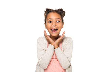 beautiful surprised african american child smiling at camera isolated on whiteの写真素材