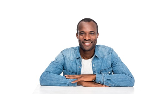 portrait of handsome african american man smiling at camera isolated on whiteの写真素材