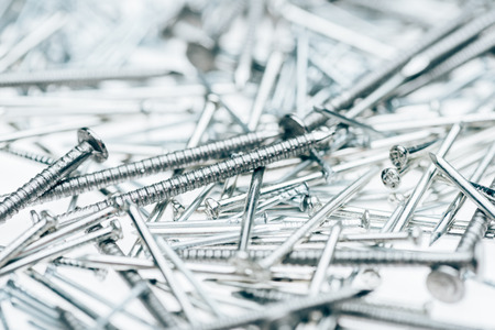 close up view of metal framing nails isolated on whiteの写真素材
