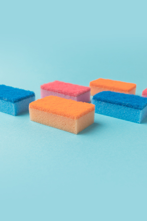 studio shot of colorful washing kitchen sponges, on blueの写真素材