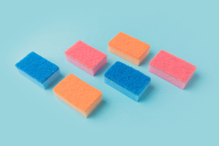 colorful washing kitchen sponges, on blueの写真素材
