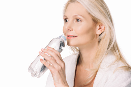 beautiful mature woman drinking water isolated on white