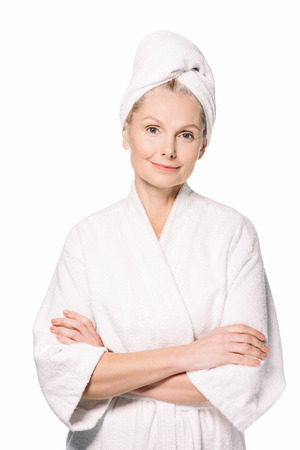 beautiful mature woman in bath robe and towel on head isolated on whiteの写真素材