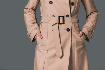 cropped shot of woman in trench coat isolated on greyの写真素材