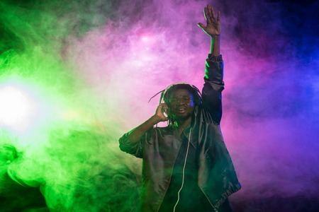 professional african american club DJ in headphones on music concert