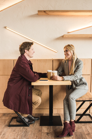 Young couple sitting with a coffee in a cafeの写真素材