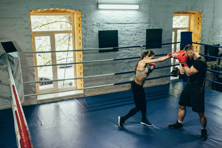 high angle view of young couple of boxers training on boxing ringの写真素材