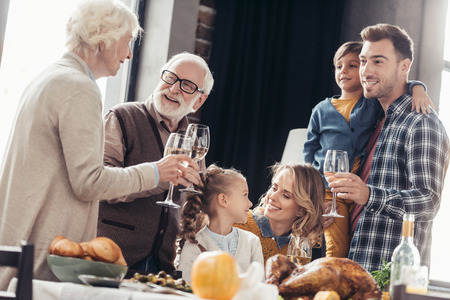 happy family toasting with wine glasses on holiday dinner