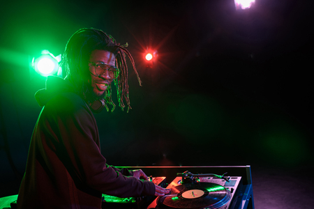 professional african american club DJ with sound mixer in nightclub の写真素材