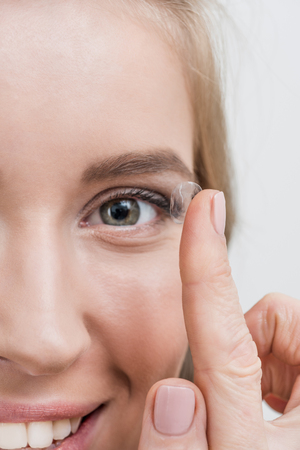 close up of young smiling woman with contact lensの写真素材