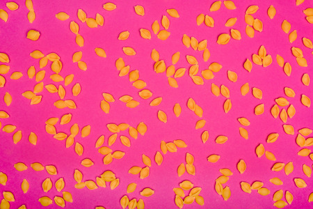 messy flat lay composition of raw pasta on pinkの写真素材