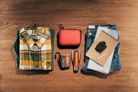 top view of travel items set on wooden tableの写真素材