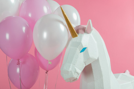 Bunch of balloons by party unicorn isolated on pinkの写真素材
