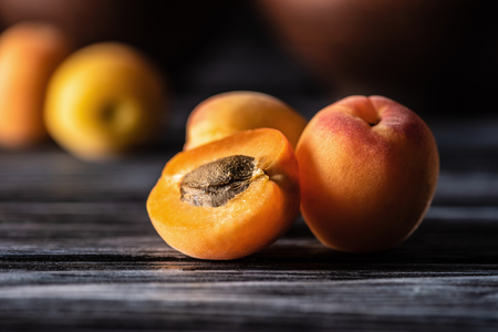 selective focus of ripe apricots on wooden tableの写真素材