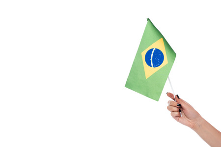 Cropped image of hand holding brazilian flag, isolated on whiteの写真素材