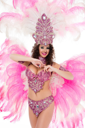 happy woman in carnival costume looking at camera, isolated on whiteの写真素材
