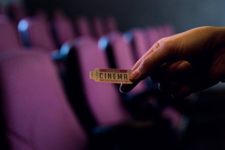 cropped view of person holding cinema ticket in hand