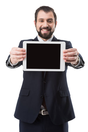 smiling businessman showing digital tablet with blank screen, isolated on whiteの写真素材