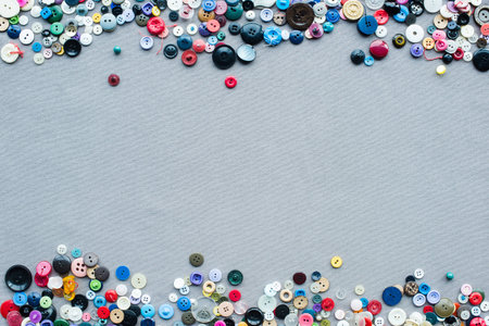 top view of colorful buttons frame on grey cloth background