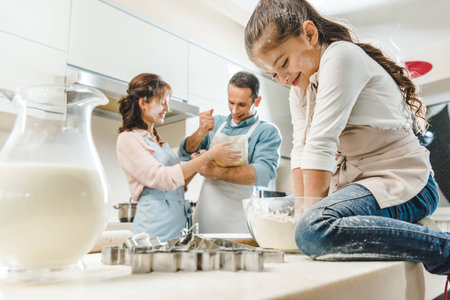 happy caucasian family in flour making dough at kitchen