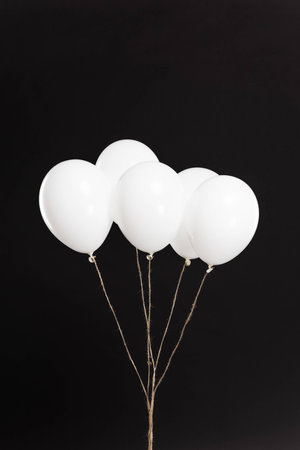 Bundle of white balloons isolated on blackの写真素材