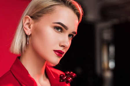 portrait of attractive stylish girl in red jacket with boutonniere