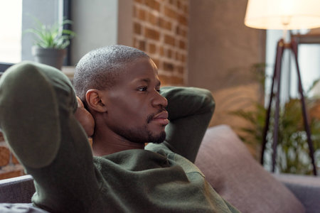 portrait of young pensive african american man looking awayの写真素材
